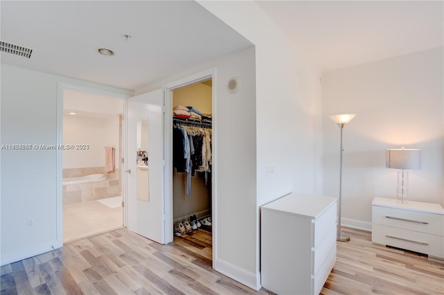 corridor with light hardwood / wood-style flooring