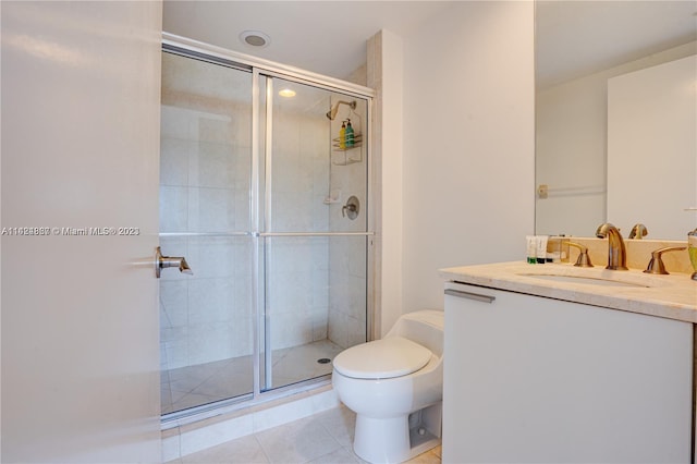 bathroom with tile floors, toilet, vanity, and an enclosed shower