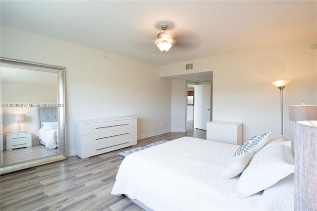 bedroom featuring light hardwood / wood-style flooring and ceiling fan