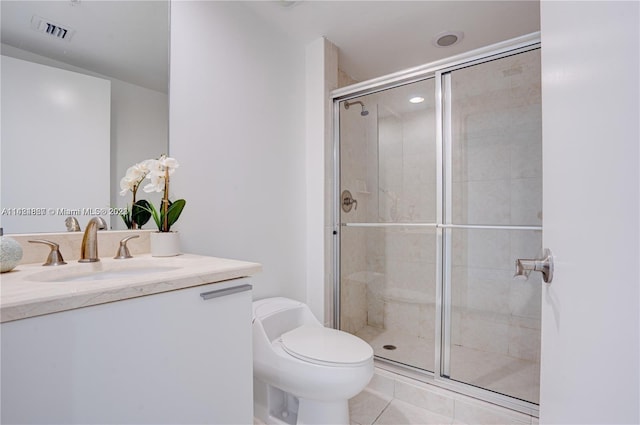 bathroom with toilet, a shower with door, tile flooring, and vanity