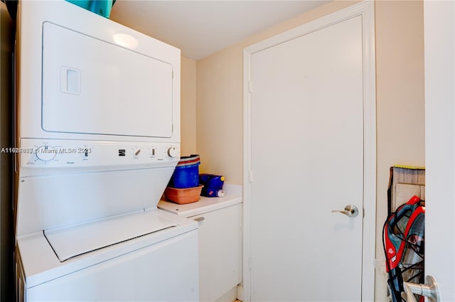 laundry area featuring stacked washing maching and dryer