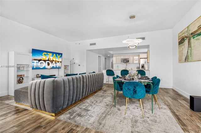 living room featuring a notable chandelier and hardwood / wood-style flooring