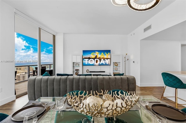 living room with light hardwood / wood-style floors and expansive windows