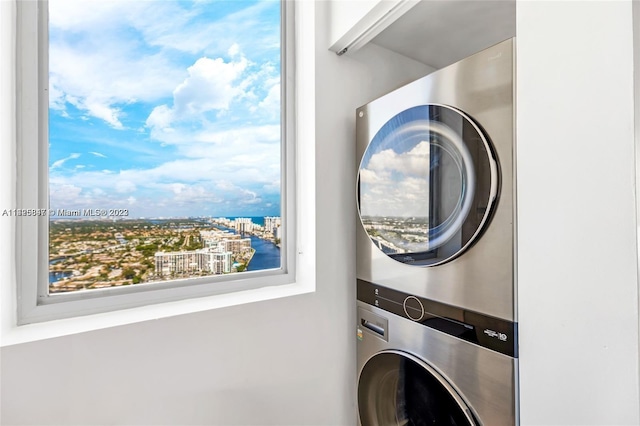 clothes washing area featuring stacked washer and dryer