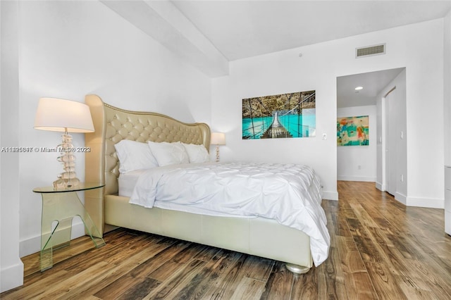 bedroom with dark wood-type flooring