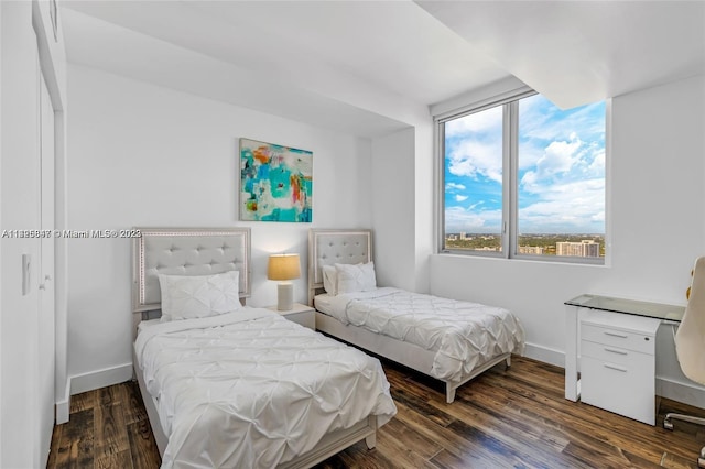 bedroom featuring dark hardwood / wood-style flooring and multiple windows