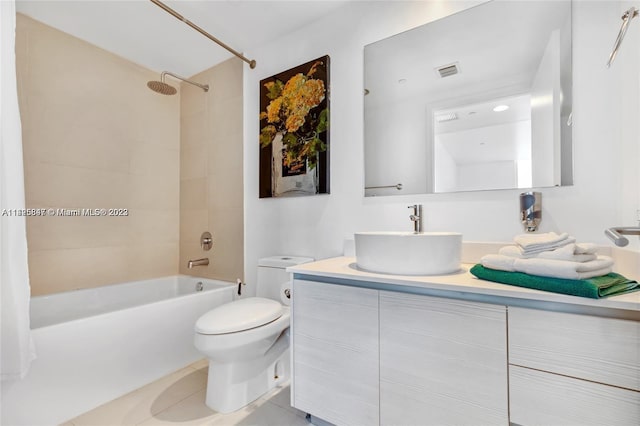 full bathroom featuring tiled shower / bath, toilet, tile floors, and oversized vanity