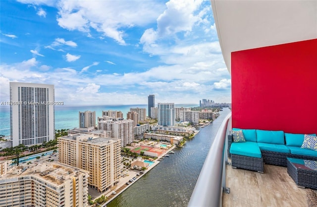 balcony featuring a water view and outdoor lounge area