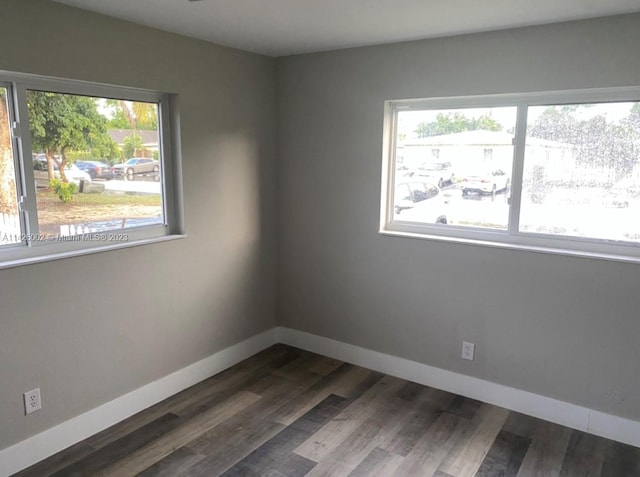 spare room with dark hardwood / wood-style floors