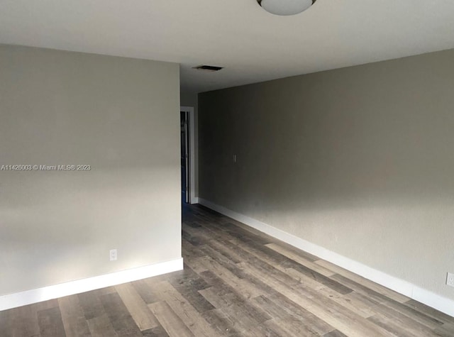 empty room with dark hardwood / wood-style floors