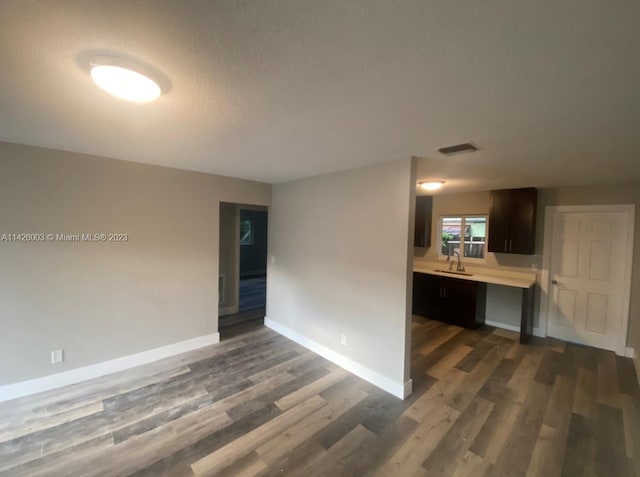 empty room with sink and dark wood-type flooring