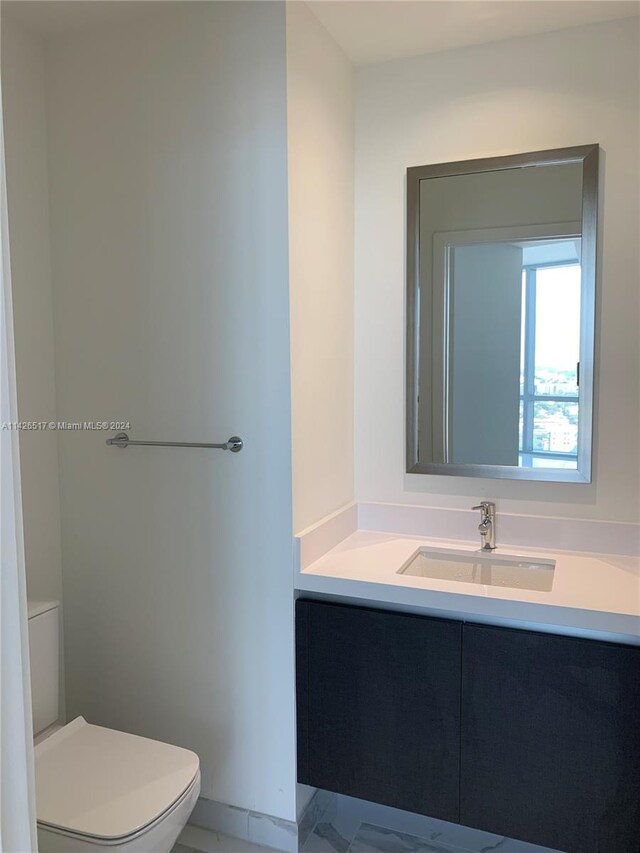 bathroom featuring vanity, toilet, and tile patterned floors