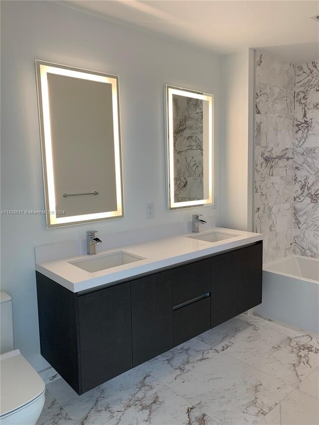 bathroom featuring tile patterned floors, double sink vanity, and toilet