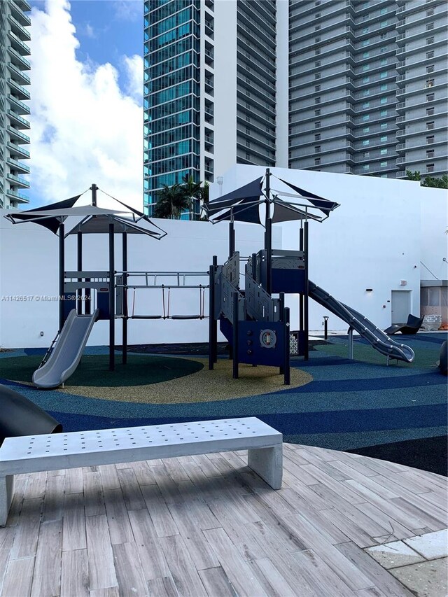 view of playground featuring a wooden deck