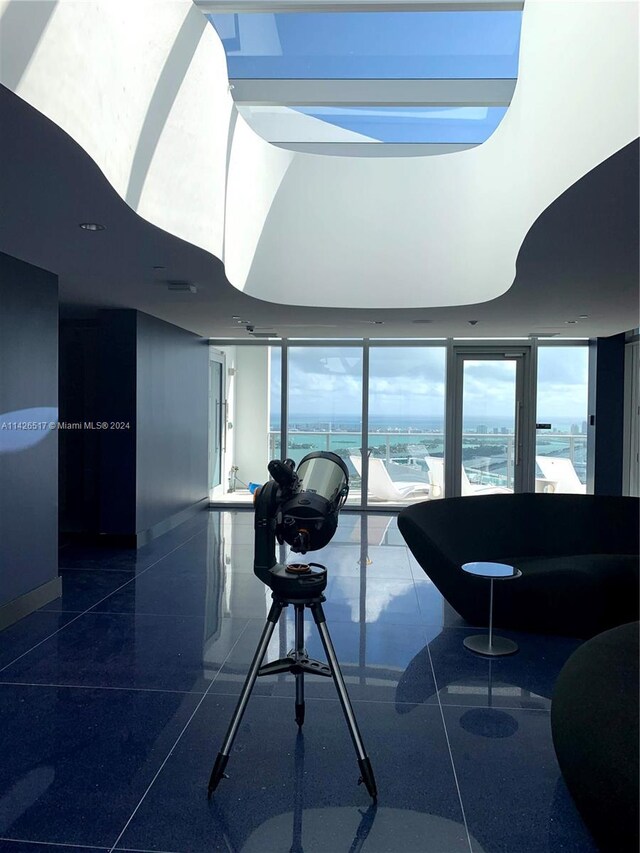 interior space with a water view and tile patterned flooring