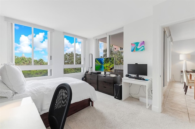 carpeted bedroom featuring tile patterned floors and baseboards