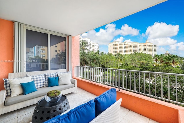 balcony with an outdoor living space and a view of city