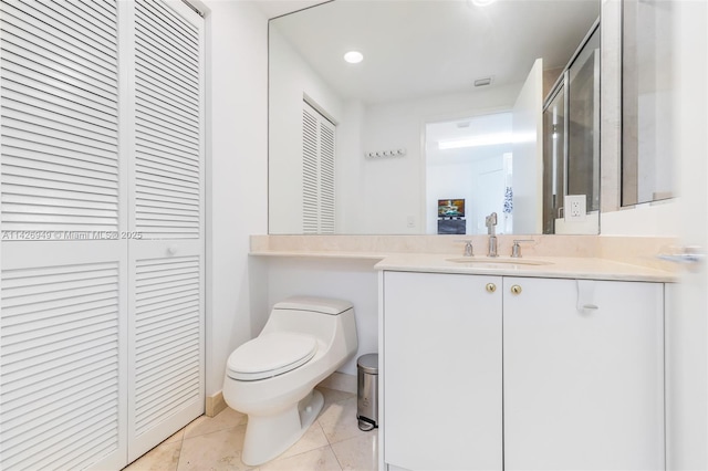 bathroom with tile patterned floors, visible vents, toilet, a closet, and vanity