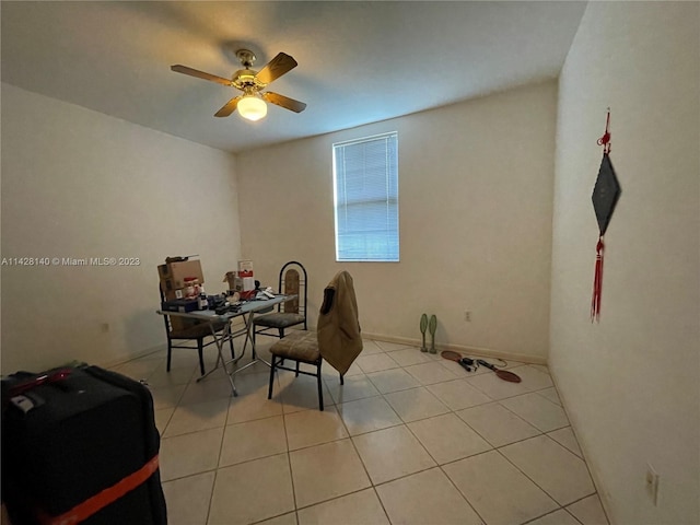 dining space featuring light tile floors and ceiling fan