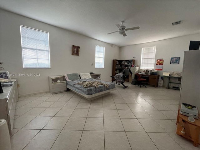 tiled living room with plenty of natural light and ceiling fan