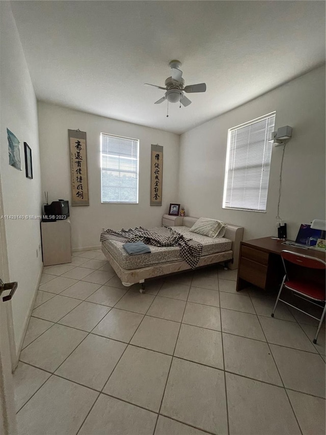 bedroom with light tile floors and ceiling fan