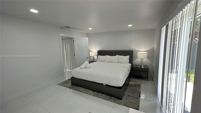 bedroom with access to outside and light tile floors