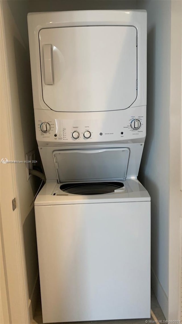 laundry area with stacked washer and clothes dryer