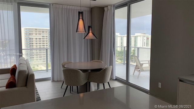 dining space featuring floor to ceiling windows