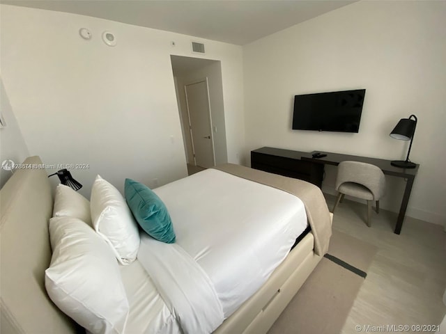 bedroom with hardwood / wood-style flooring