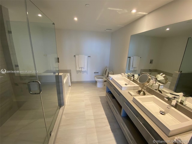 bathroom with tile flooring, dual sinks, oversized vanity, walk in shower, and a bidet