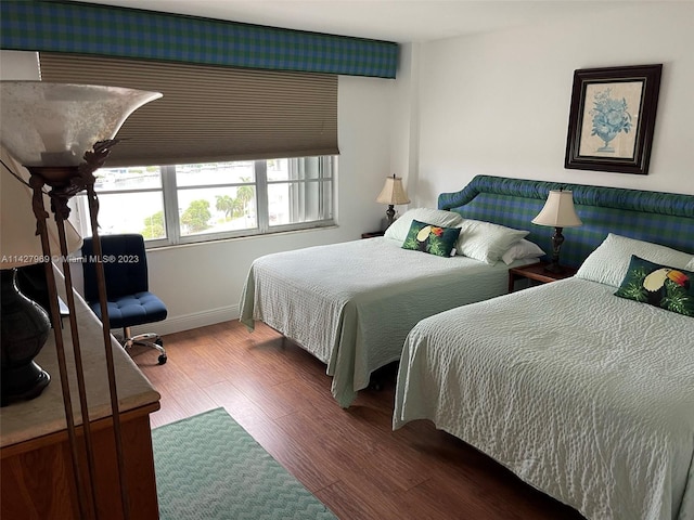 bedroom with dark hardwood / wood-style floors