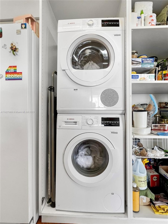 laundry area featuring stacked washer / drying machine