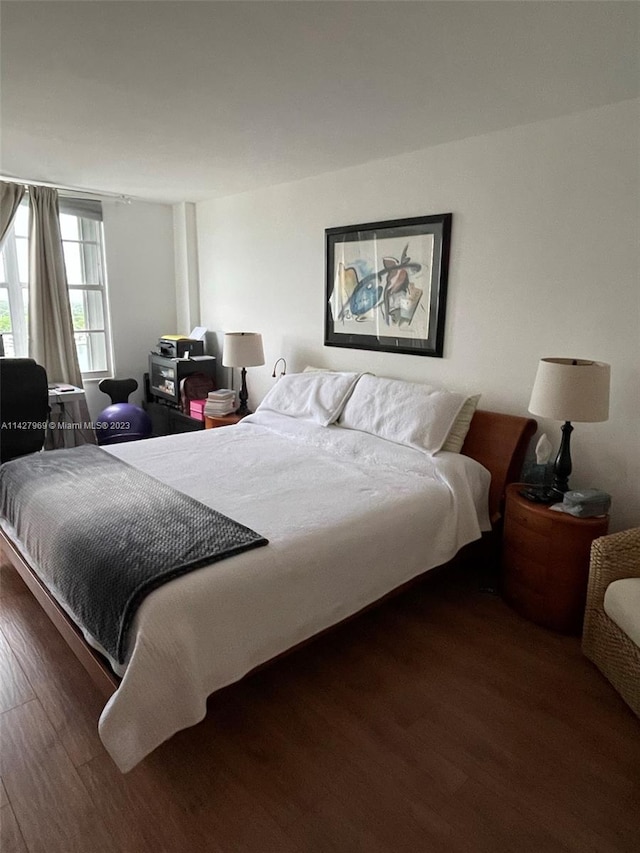 bedroom featuring dark hardwood / wood-style flooring