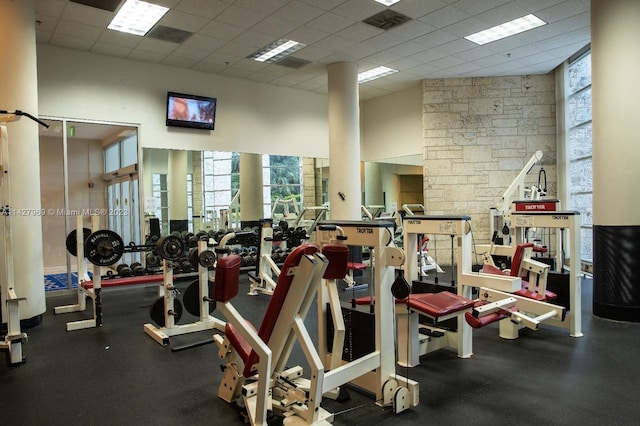 gym featuring a high ceiling and a paneled ceiling