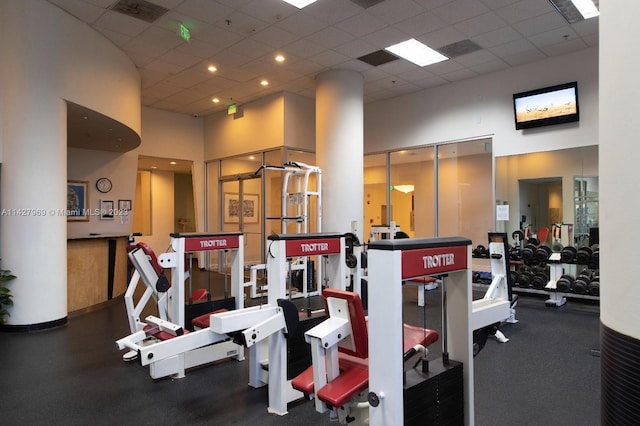 workout area with a high ceiling and a drop ceiling