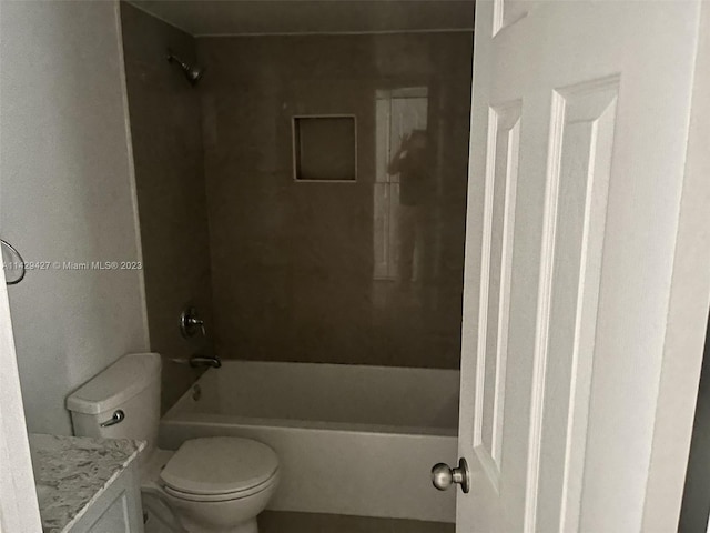 full bathroom with vanity, tiled shower / bath combo, and toilet