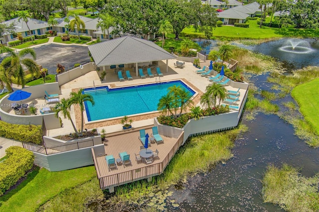 view of pool featuring a patio, a yard, and a deck with water view