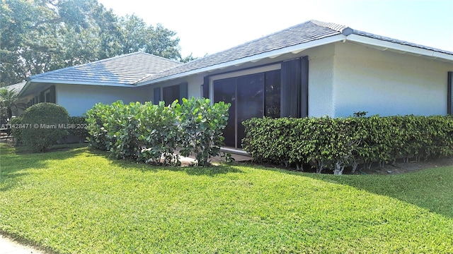 view of home's exterior featuring a yard