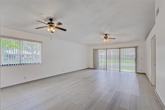 unfurnished room with ceiling fan, a textured ceiling, and light hardwood / wood-style flooring