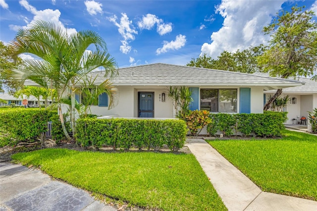 ranch-style house featuring a front lawn