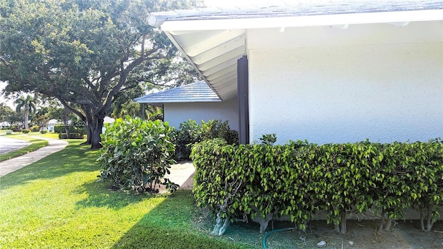 view of side of home featuring a lawn