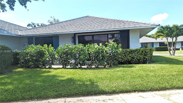 view of side of home with a yard