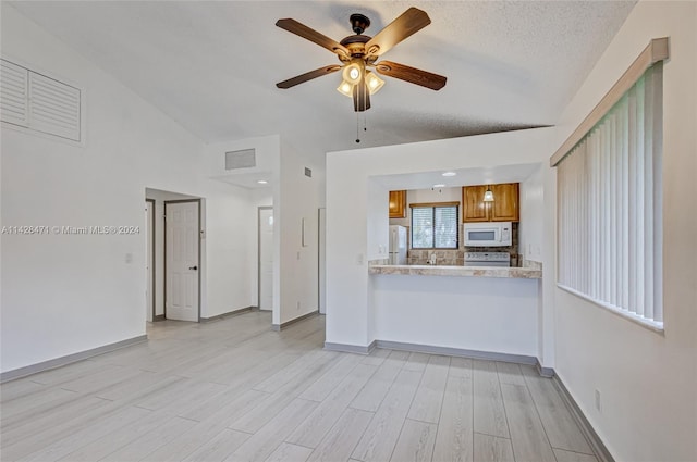 unfurnished living room featuring light hardwood / wood-style floors, a textured ceiling, and ceiling fan