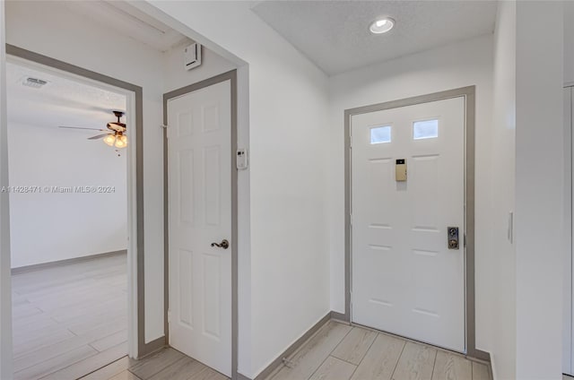 entrance foyer featuring light hardwood / wood-style floors and ceiling fan