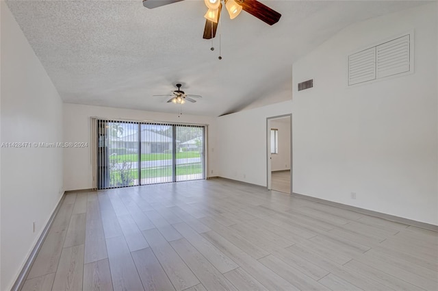 spare room featuring a textured ceiling, ceiling fan, vaulted ceiling, and light hardwood / wood-style floors