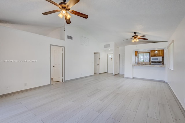 unfurnished living room with high vaulted ceiling, ceiling fan, and light hardwood / wood-style flooring