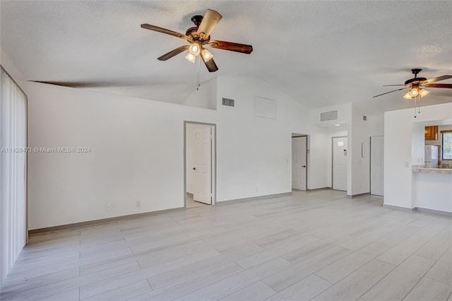 unfurnished living room with high vaulted ceiling, ceiling fan, and a textured ceiling