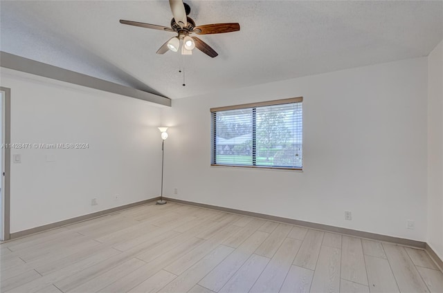 empty room featuring light hardwood / wood-style floors, ceiling fan, and lofted ceiling