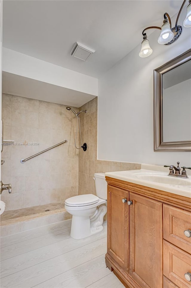 bathroom featuring vanity, toilet, and hardwood / wood-style flooring