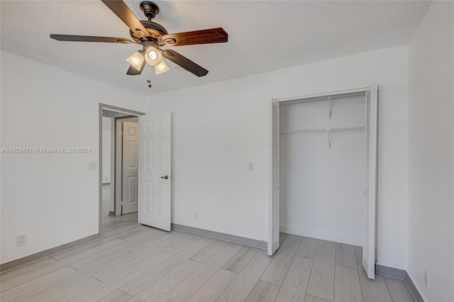 unfurnished bedroom with a textured ceiling, ceiling fan, a closet, and light hardwood / wood-style floors